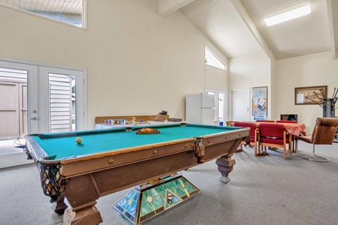 a pool table in the living room of a house