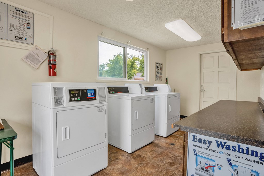 the laundry room is equipped with washes and dryers and has a counter top