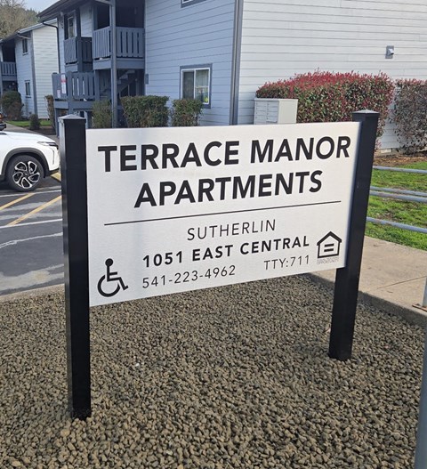 A sign for Terrace Manor Apartments in Sutherlin, OR.