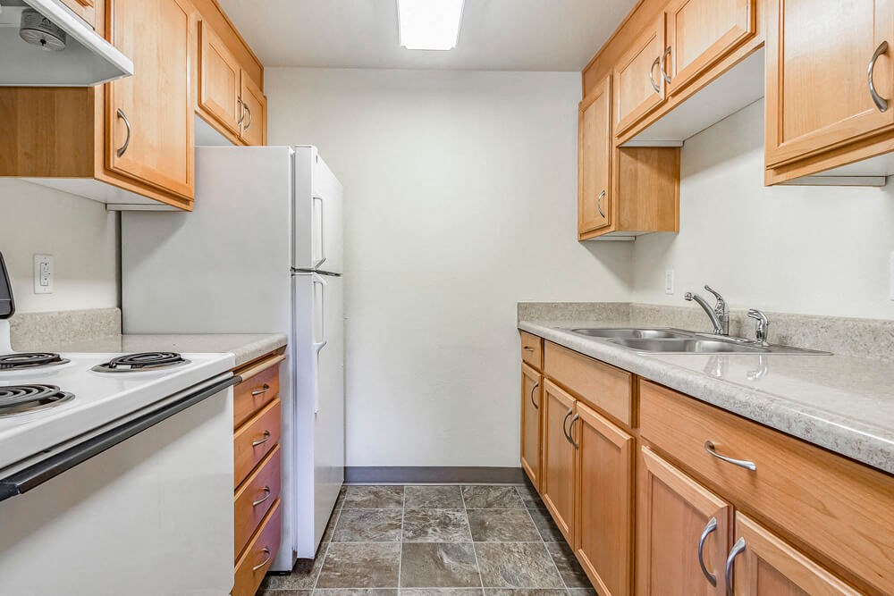a kitchen with a stove refrigerator and sink