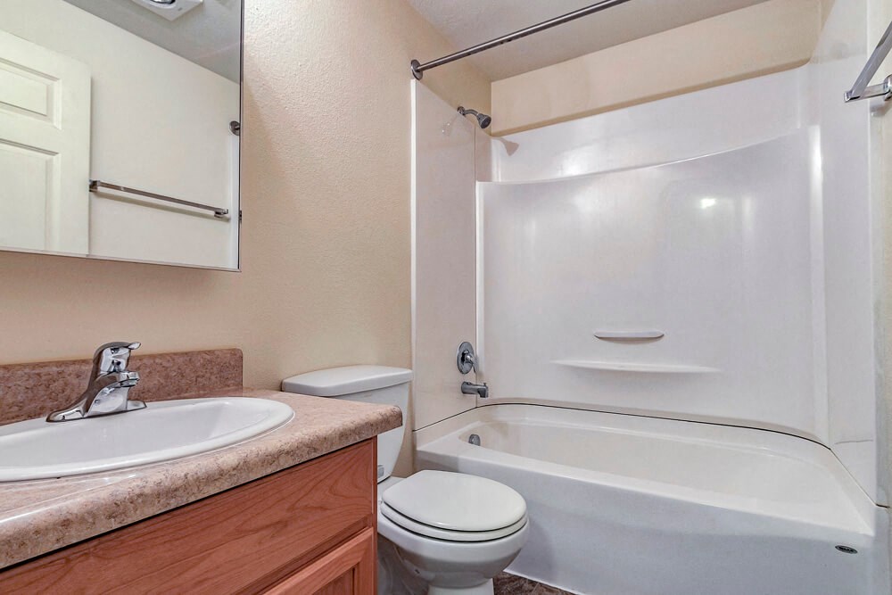 a bathroom with a sink toilet and a bath tub