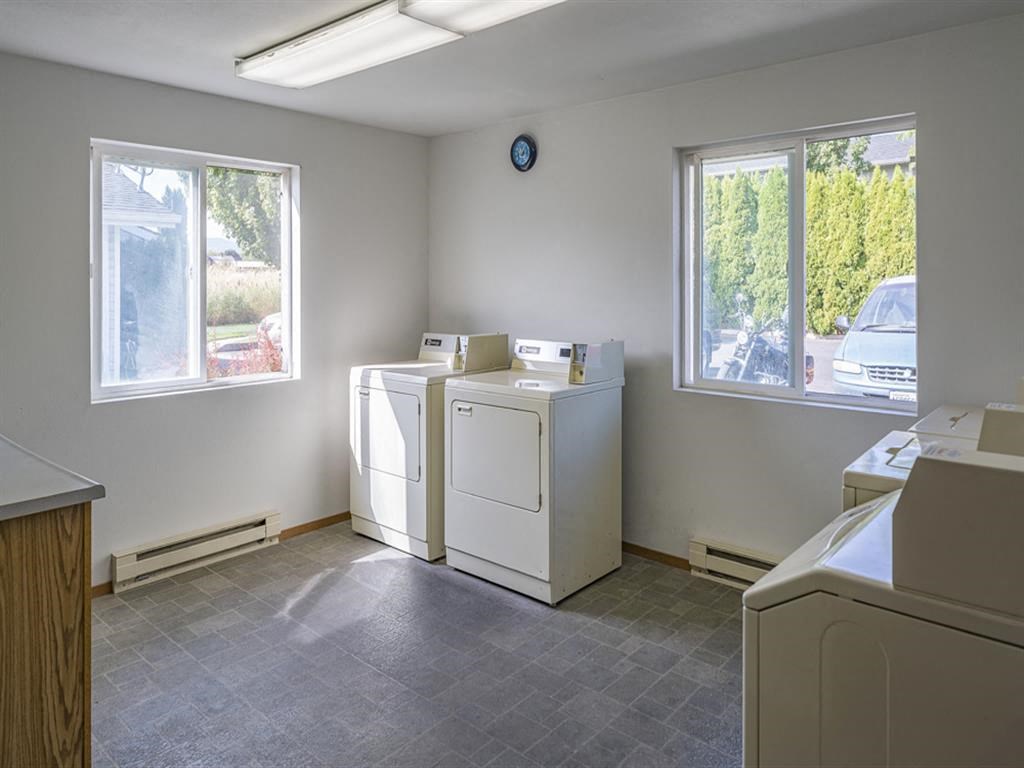 an empty laundry room with two washes in it