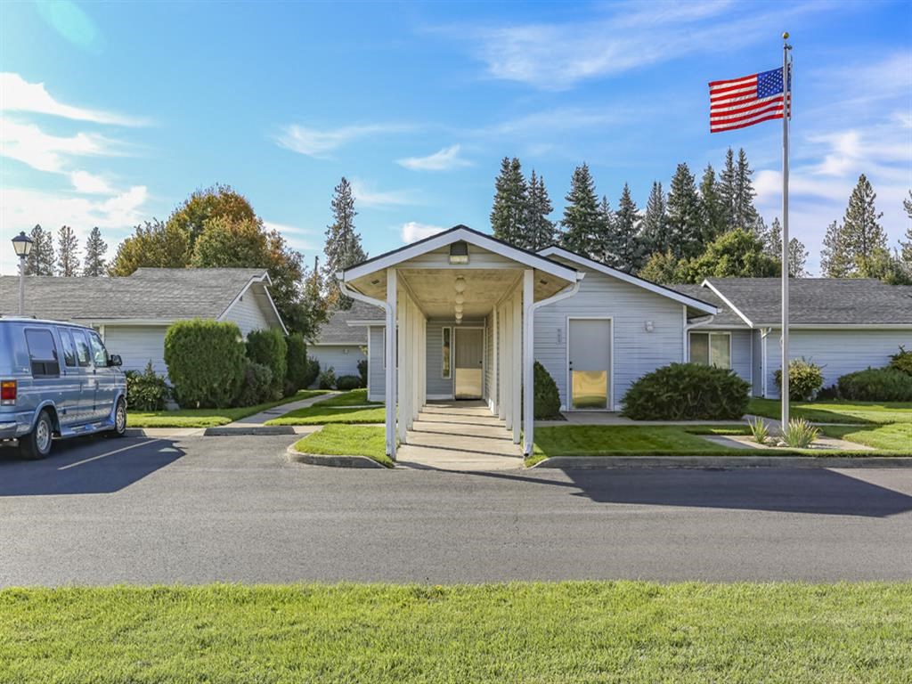 a house with an flag and a van parked in front of it