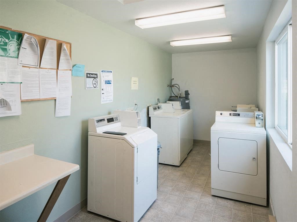 a laundry room with washes and dryers in it