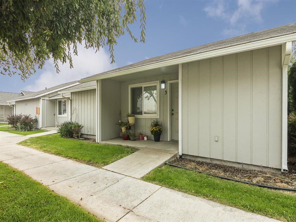 a white house with a sidewalk in front of it