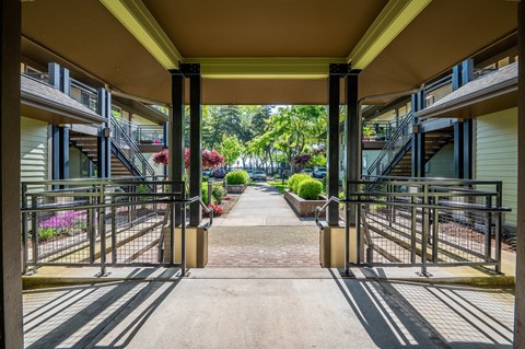 A view of a pathway leading to a residential area with houses on both sides.