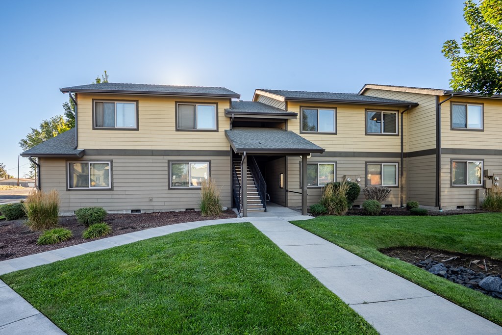 A modern house with a well-maintained lawn in front.