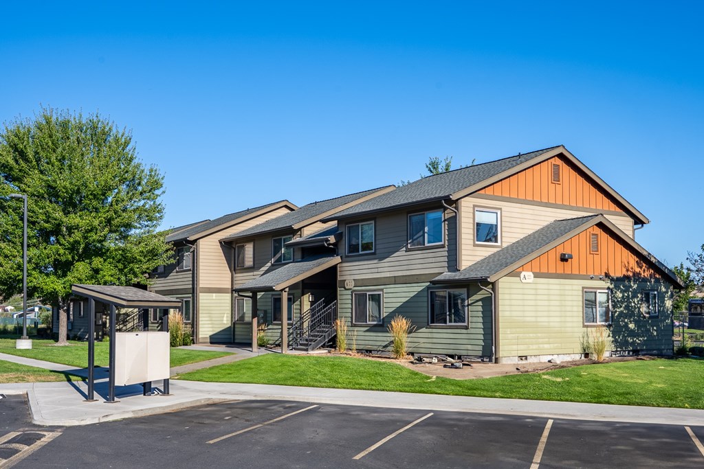 A large building with a parking lot in front.