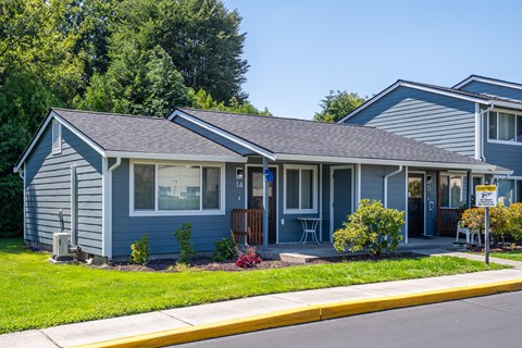 A blue house with a yellow caution sign in front.