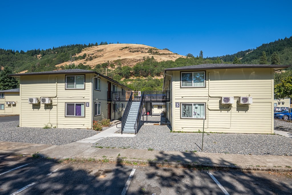 A small building with a staircase leading to the entrance.