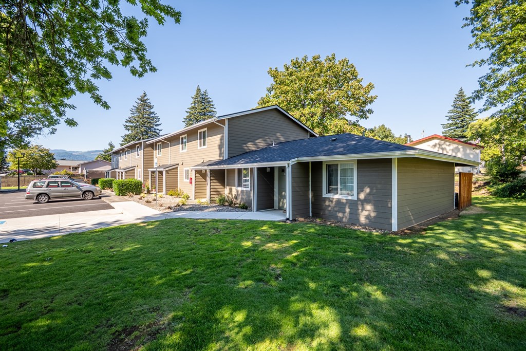 A house with a car parked in front.