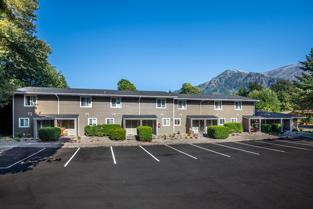 A large building with a parking lot in front of it.