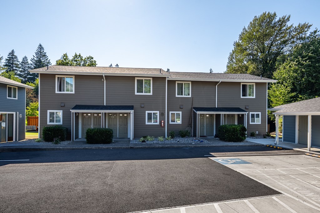 A row of houses with a driveway in front.