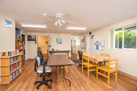 a dining room with a table and chairs and a ceiling fan