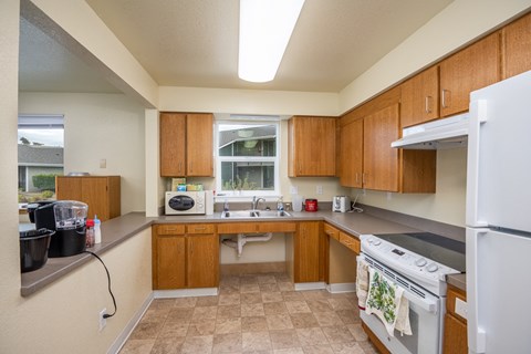 a kitchen with wooden cabinets and a white stove and refrigerator