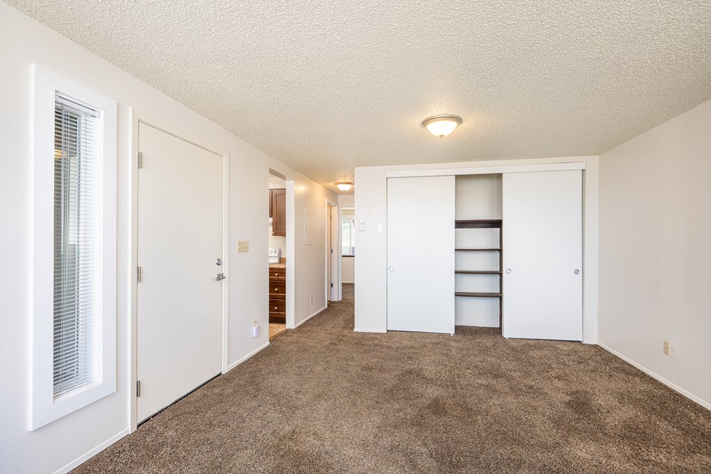A room with a carpeted floor and white walls.