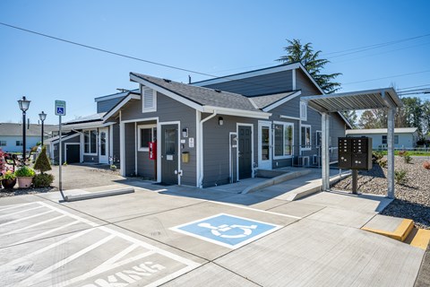 A parking lot with a handicap parking sign painted on the pavement.