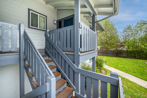 A house with a grey staircase and a grey railing.