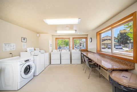 A laundry room with washers and dryers.