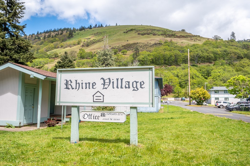 a sign that reads rhine village in front of a house