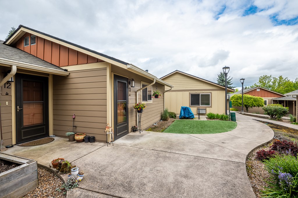 a row of houses with a driveway and a yard