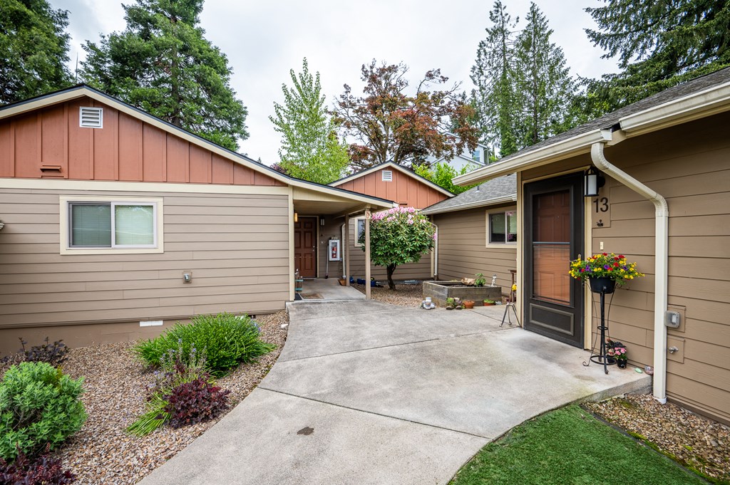 a walkway in front of a house with a driveway