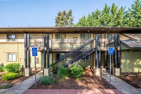 an exterior view of a building with stairs and balconies
