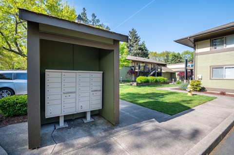 a mail box in front of a house with a driveway