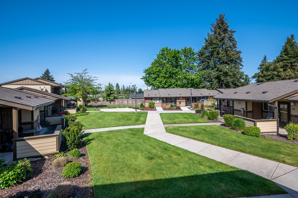 a view of a neighborhood with houses and lawns and trees
