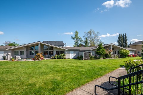 the view of a house with a lawn and a sidewalk