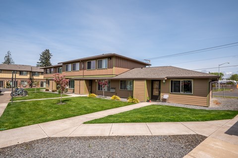 a view of the front of a house with a lawn and sidewalk