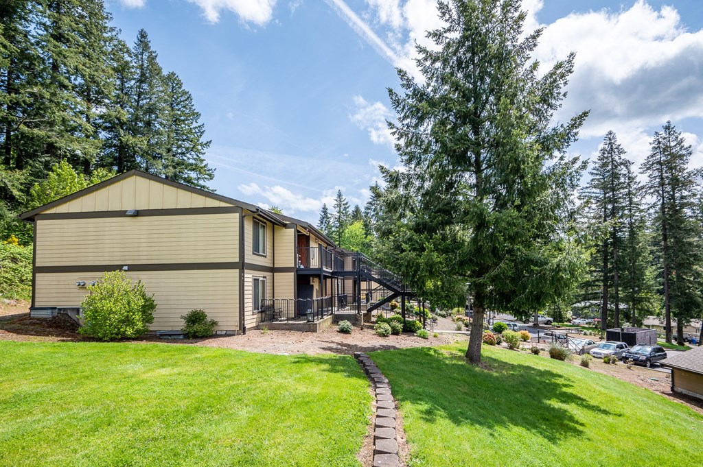 the view of a house with a yard and a tree