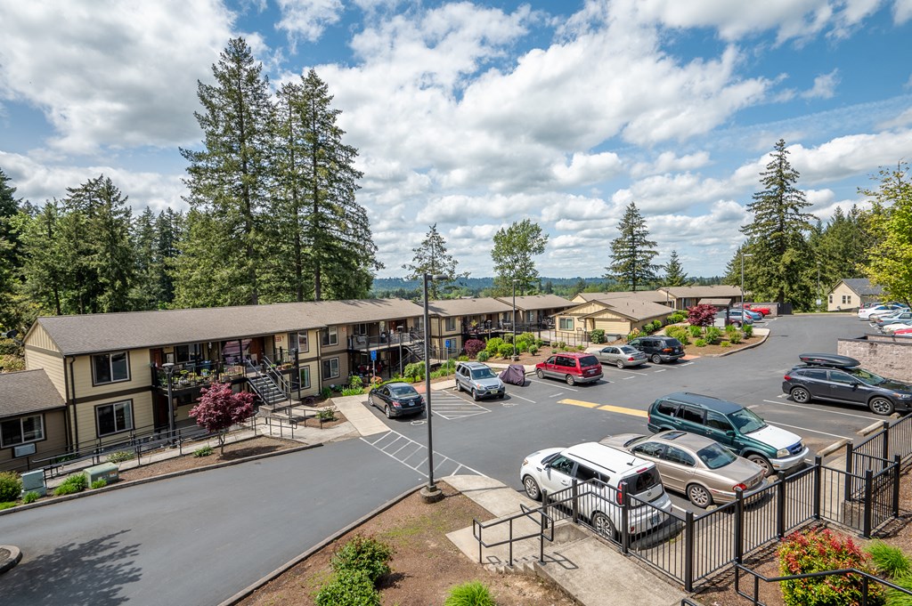 an aerial view of a hotel parking lot with cars and buildings