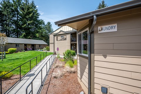 the landing at gardner street apartments building entrance and lawn