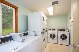 a laundry room with washer and dryer and a window