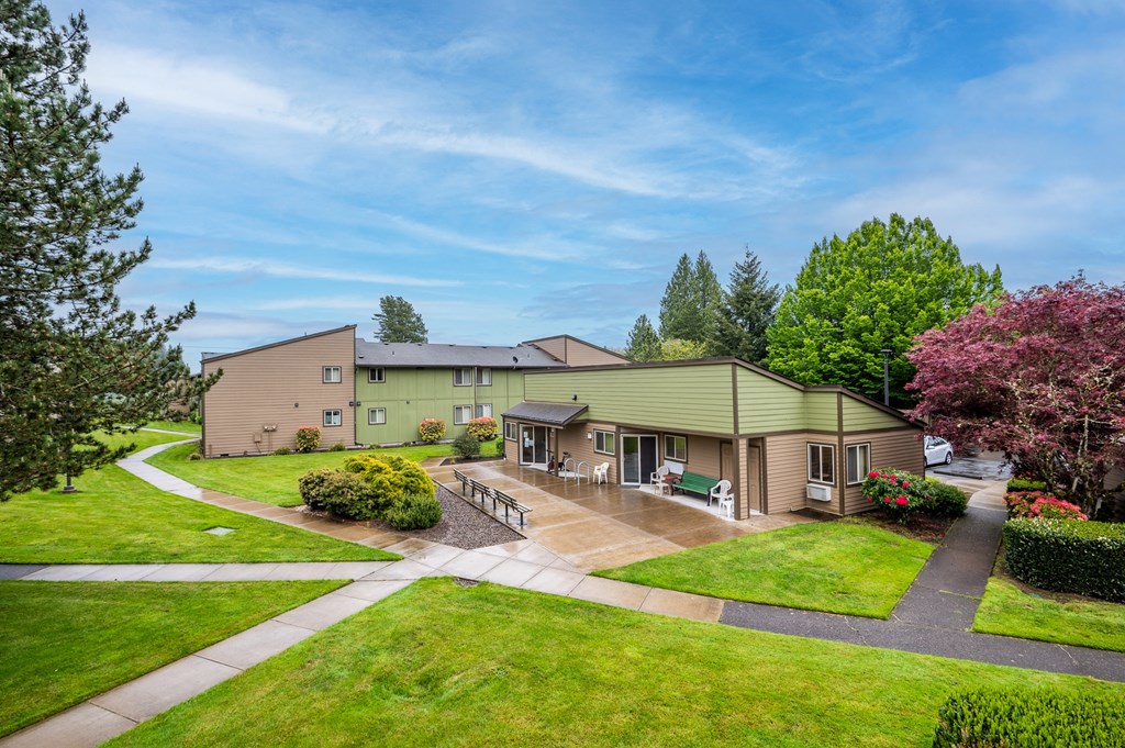 the view of a house with a yard and a patio