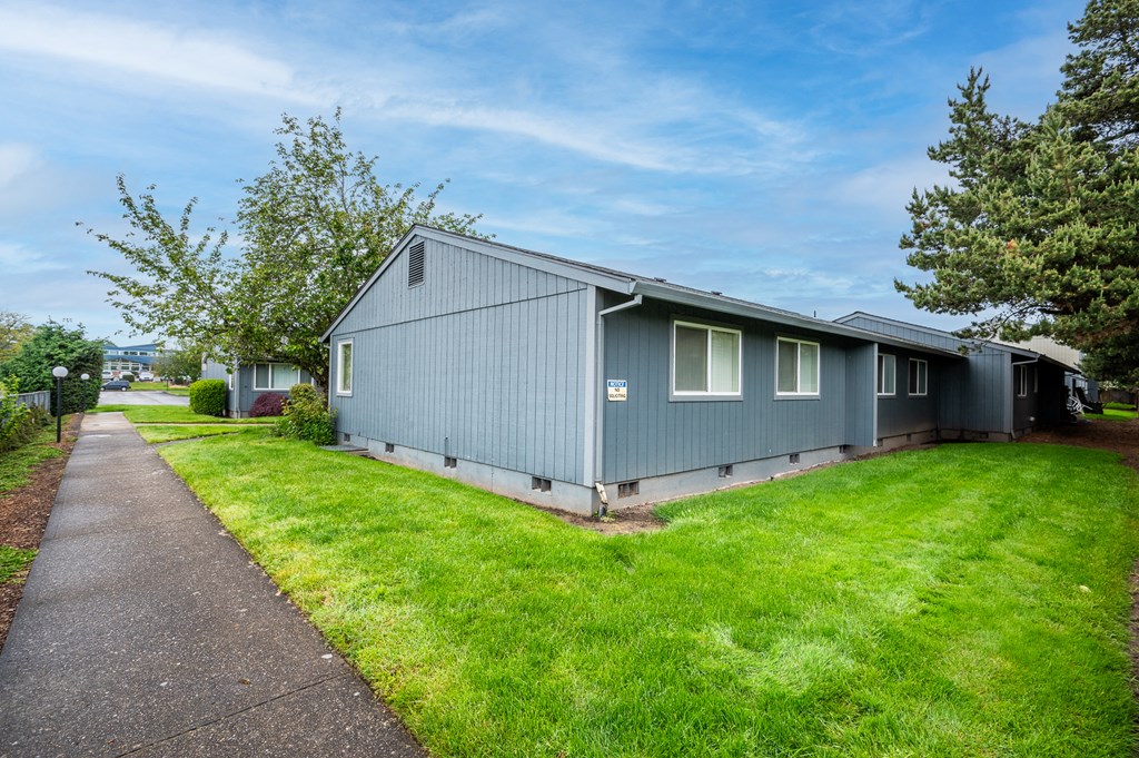 a blue house on the side of a road