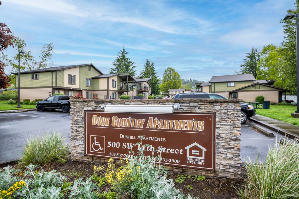 the sign for dorcas country apartments in front of a parking lot