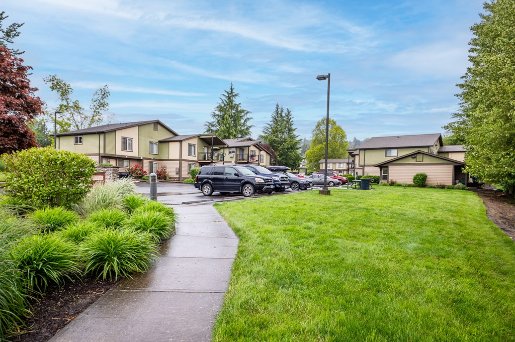 a row of houses with cars parked in front of them