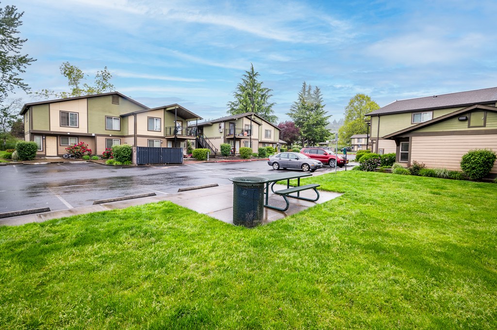 a city street with houses and a picnic table