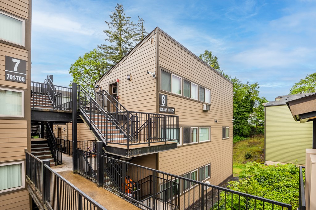 the view of a condo building with stairs and balconies