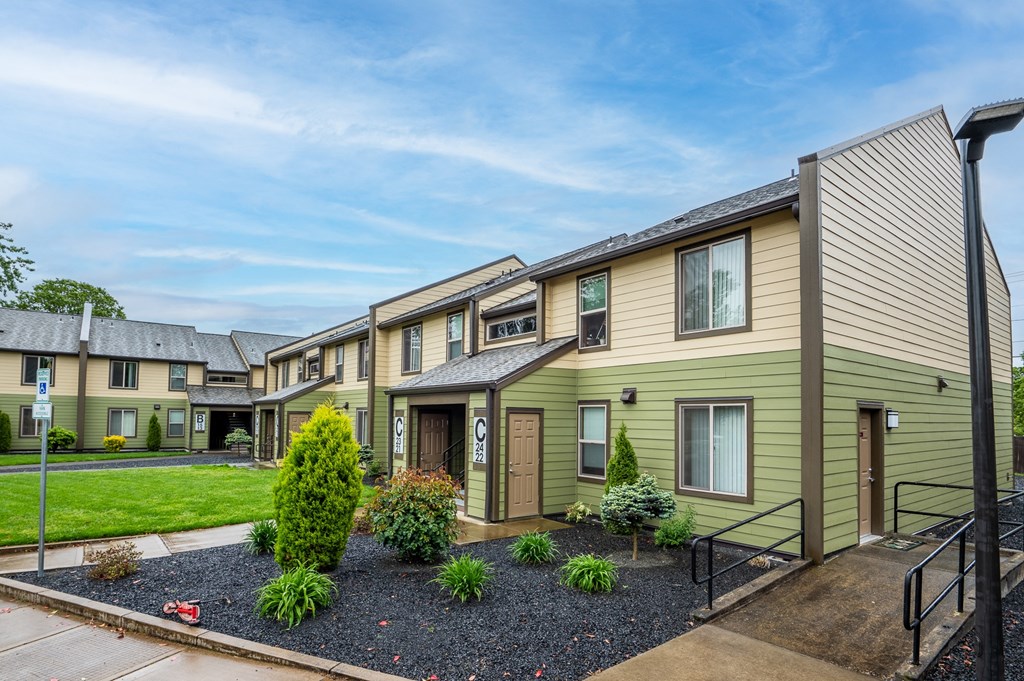 a row of houses with a yard and green grass