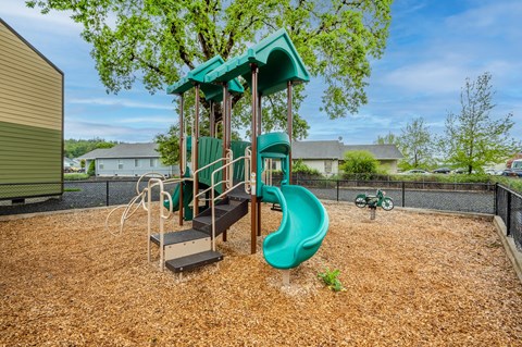 the playground at the preserve at polk apartments with a slide