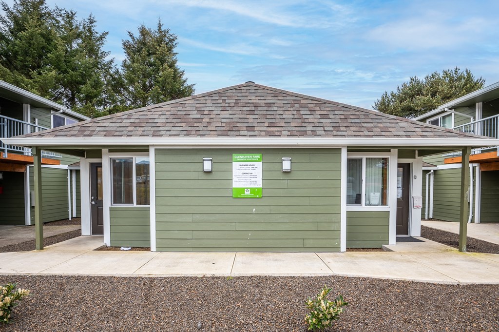 a green building with a sign on the front of it