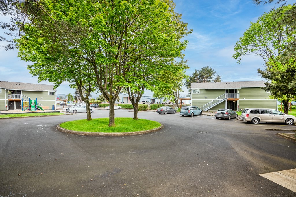 a city street with cars parked in front of buildings