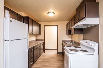 the preserve at ballantyne commons apartment kitchen with white appliances and dark cabinets