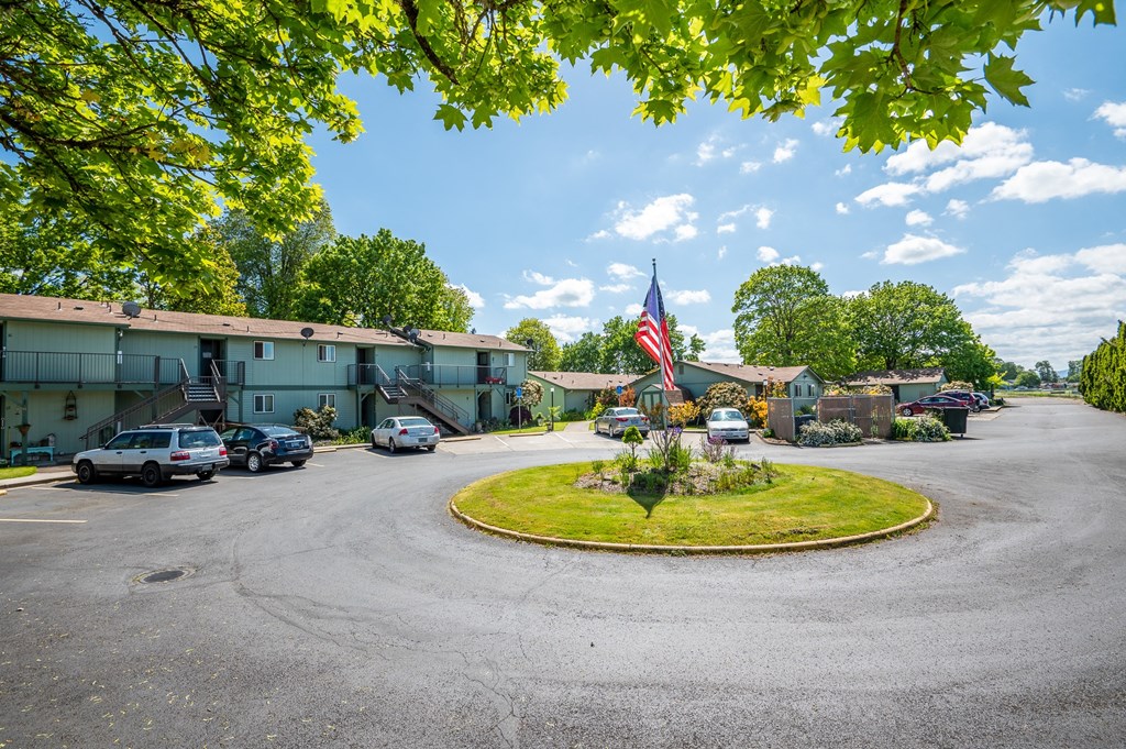 a parking lot with an flag in front of a building