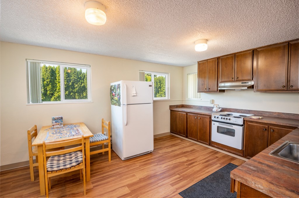 a kitchen with a dining table and a refrigerator