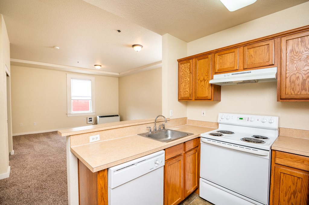 a kitchen with white appliances and wooden cabinets