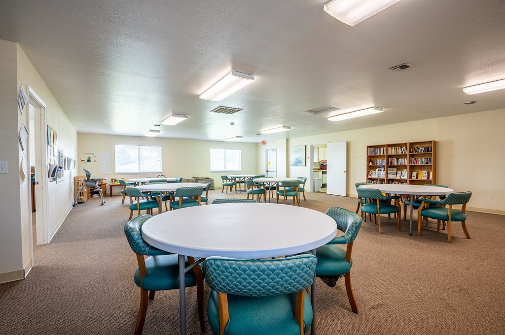 a dining room with tables and chairs and a library